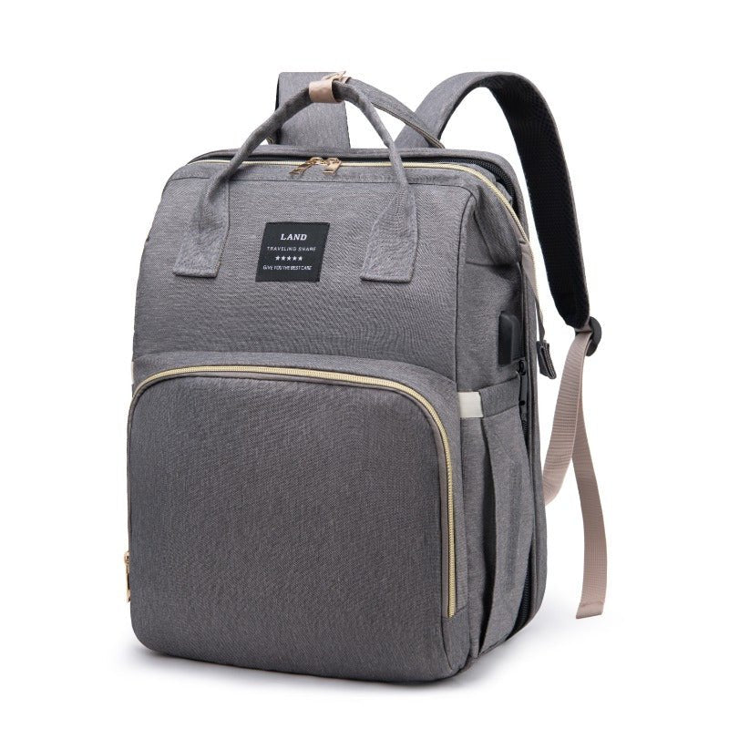 sac à dos à langer avec lit pliable gris