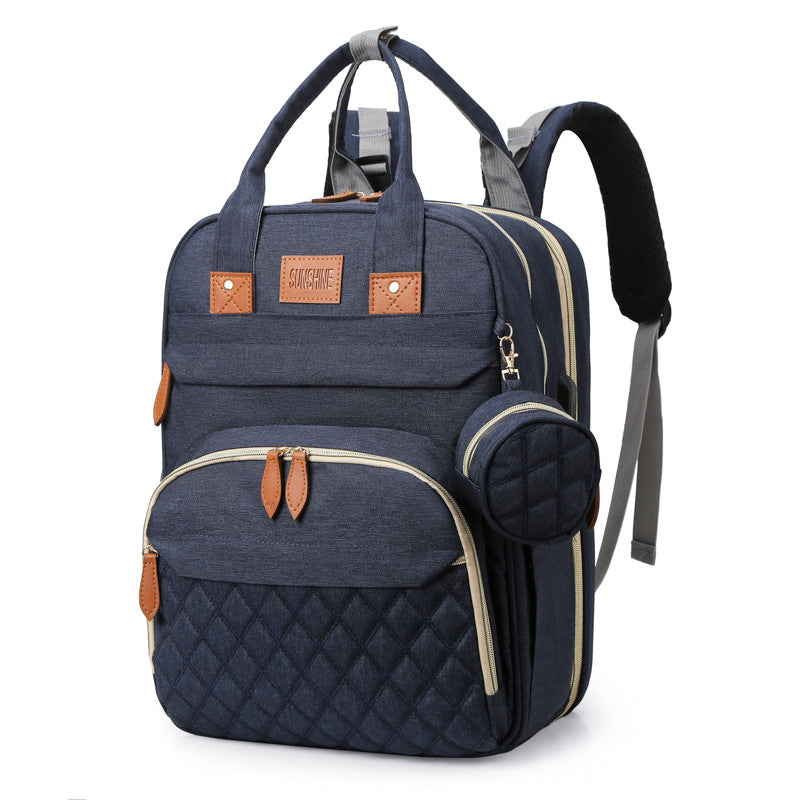sac à dos à langer lit portable couleur marine intemporel