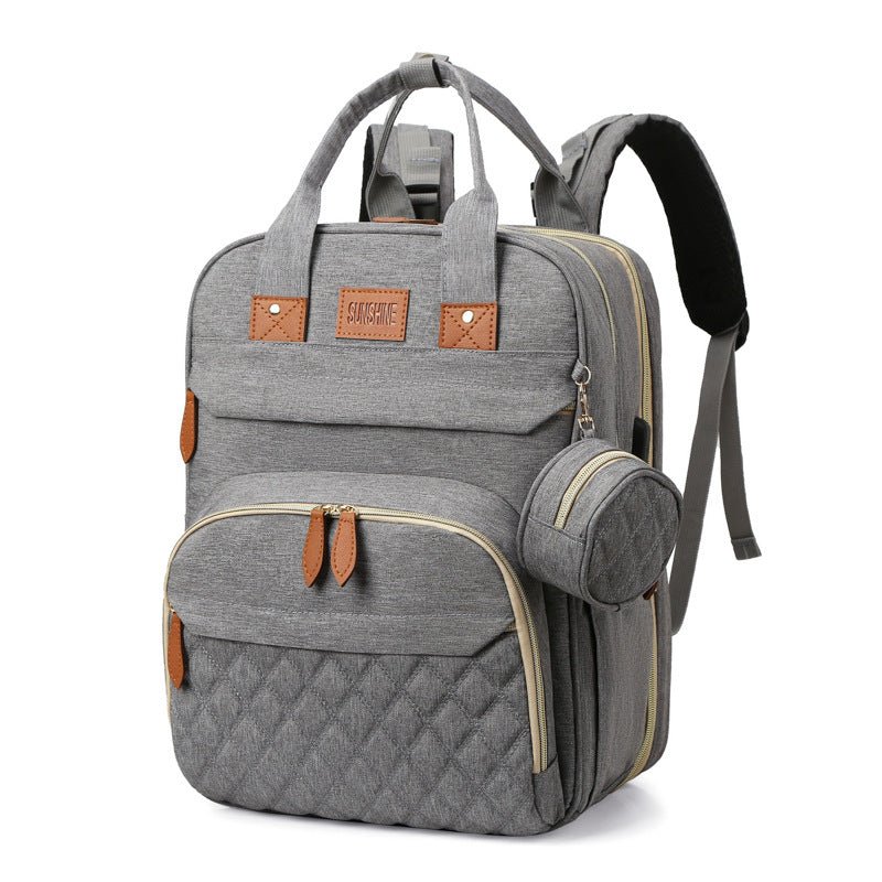 sac à dos à langer et lit portable gris