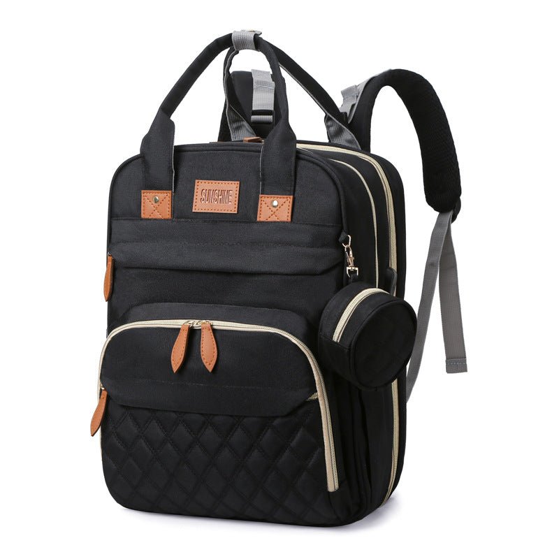 sac à dos à langer et lit portable noir