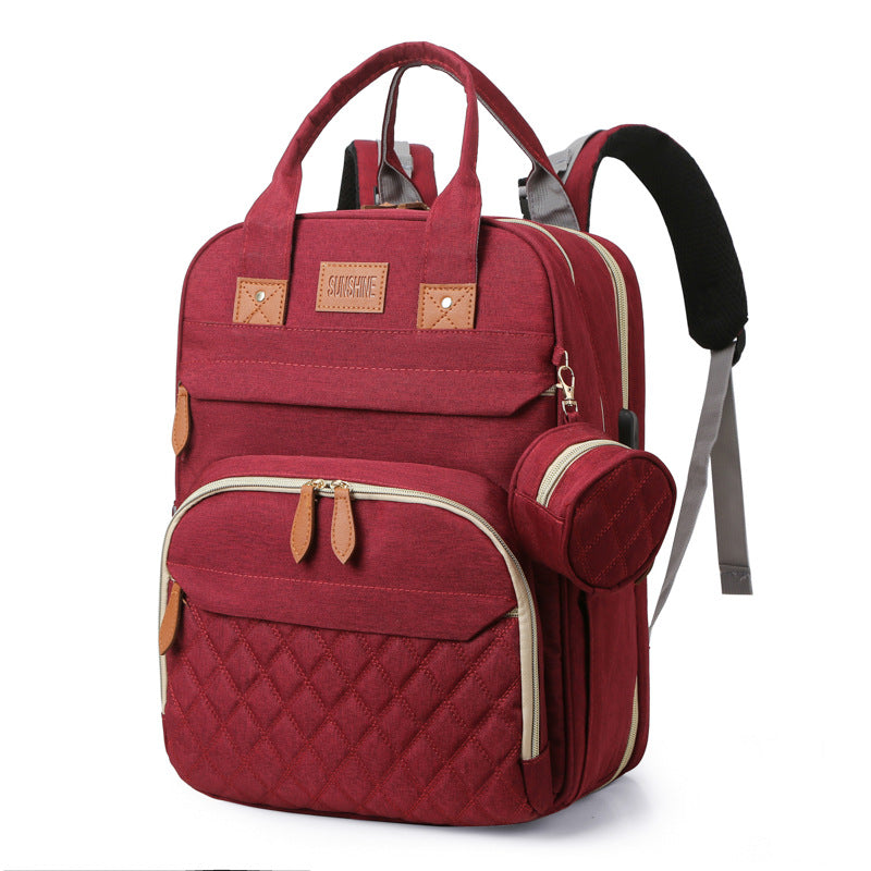 sac à dos à langer et lit portable rouge