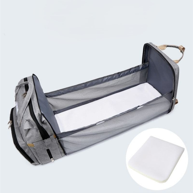 sac à dos à langer transformable avec tapis à langer