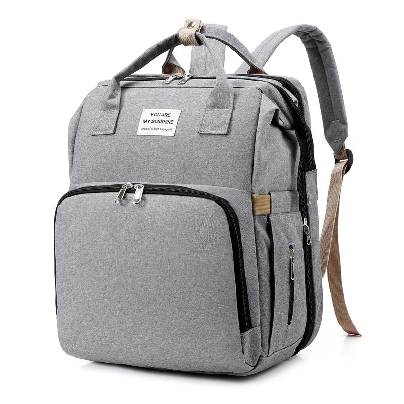 sac à dos à langer transformable gris