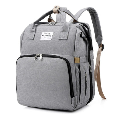 sac à dos à langer transformable gris